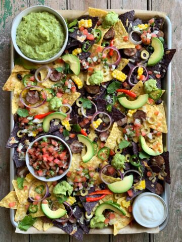 Nacho platter with fresh guacamole and Pico de Gallo and all the fixings.