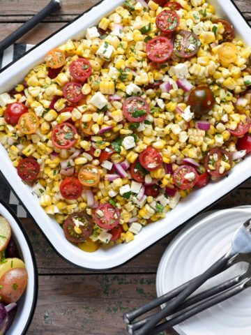Grilled corn and tomato salad with herbs and feta cheese.
