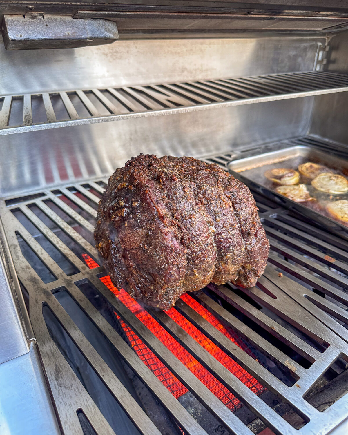 Beef is placed on the sear zone of the grill.