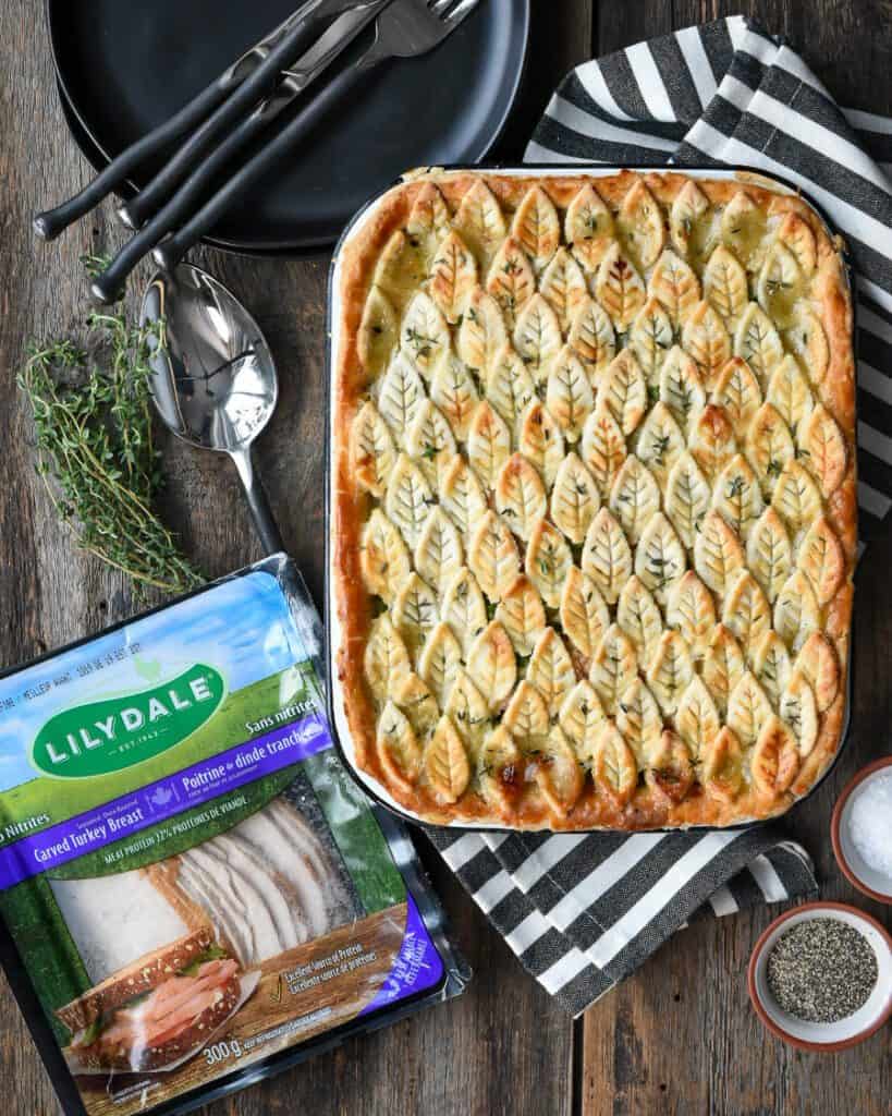 Turkey pot pie with leaf pattern crust and a package of Lilydale carved turkey breast.