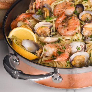 Spicy Linguine with Clams and Shrimp in a copper pan.