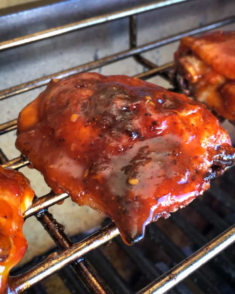 Glazed chicken thighs on the grill.
