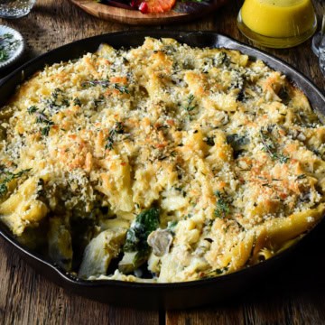 A cast-iron skillet with a creamy cauliflower pasta bake.