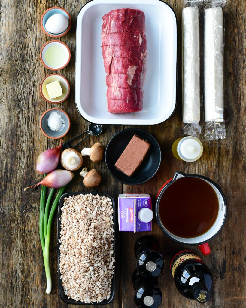 A top down image of ingredients needed for a beef wellington recipe. 