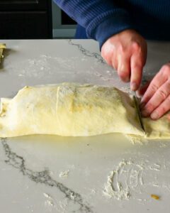 Wrap the beef wellington with puff pastry.