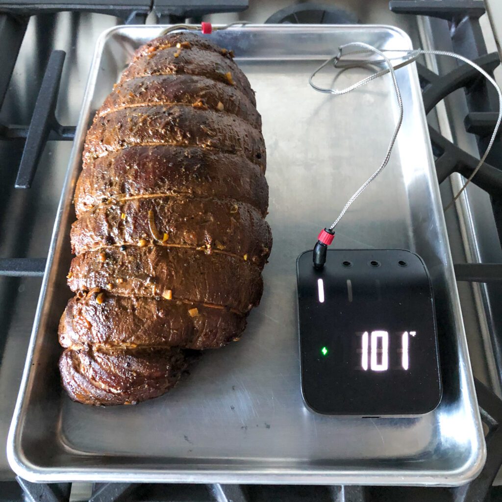 An image of grilled roast with a temperature probe reading 101 °F