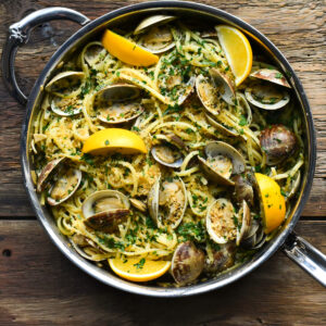A finished pan of linguine and clams with lemons