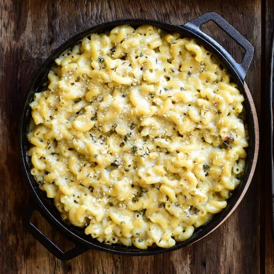 A cast iron dish with macaroni and cheese.