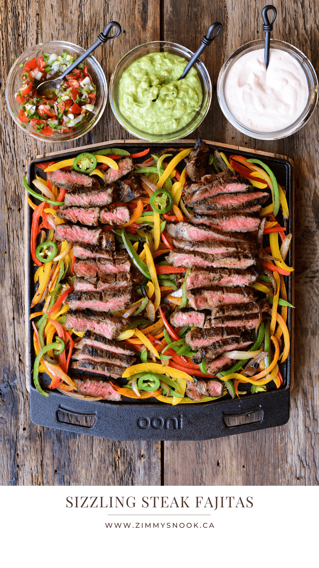 Slices of steak are laid on top of cooked peppers and onions for making fajitas