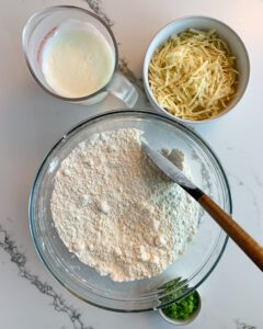 A mixing bowl with dry ingredients and the butter cubes added in.