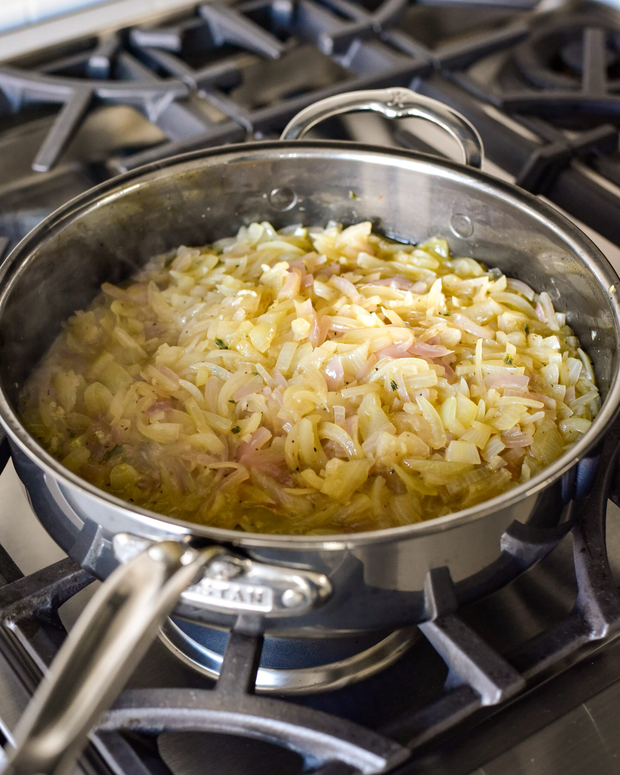 A sauté pan with braised onions.