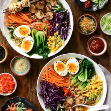 This image shows two bowls of ramen and how all the ingredients are placed in the bowl.