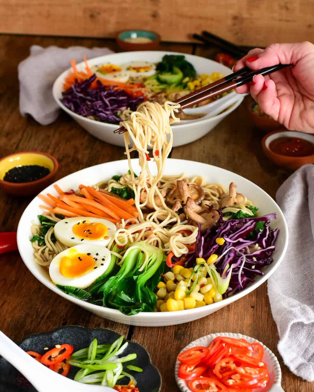 Pulling up ramen noodles from a very colourful and healthy soup!