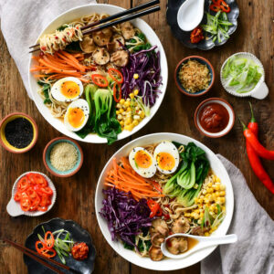 This image shows two bowls of ramen and how all the ingredients are placed in the bowl.