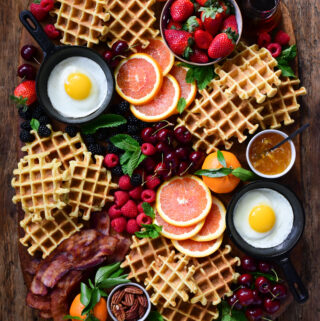 Buttermilk waffles served with fresh berries, cara cara oranges, thick cut bacon, fried eggs and local maple syrup.