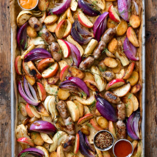 A sheet pan with roasted apples, fennel, onions and sausages.
