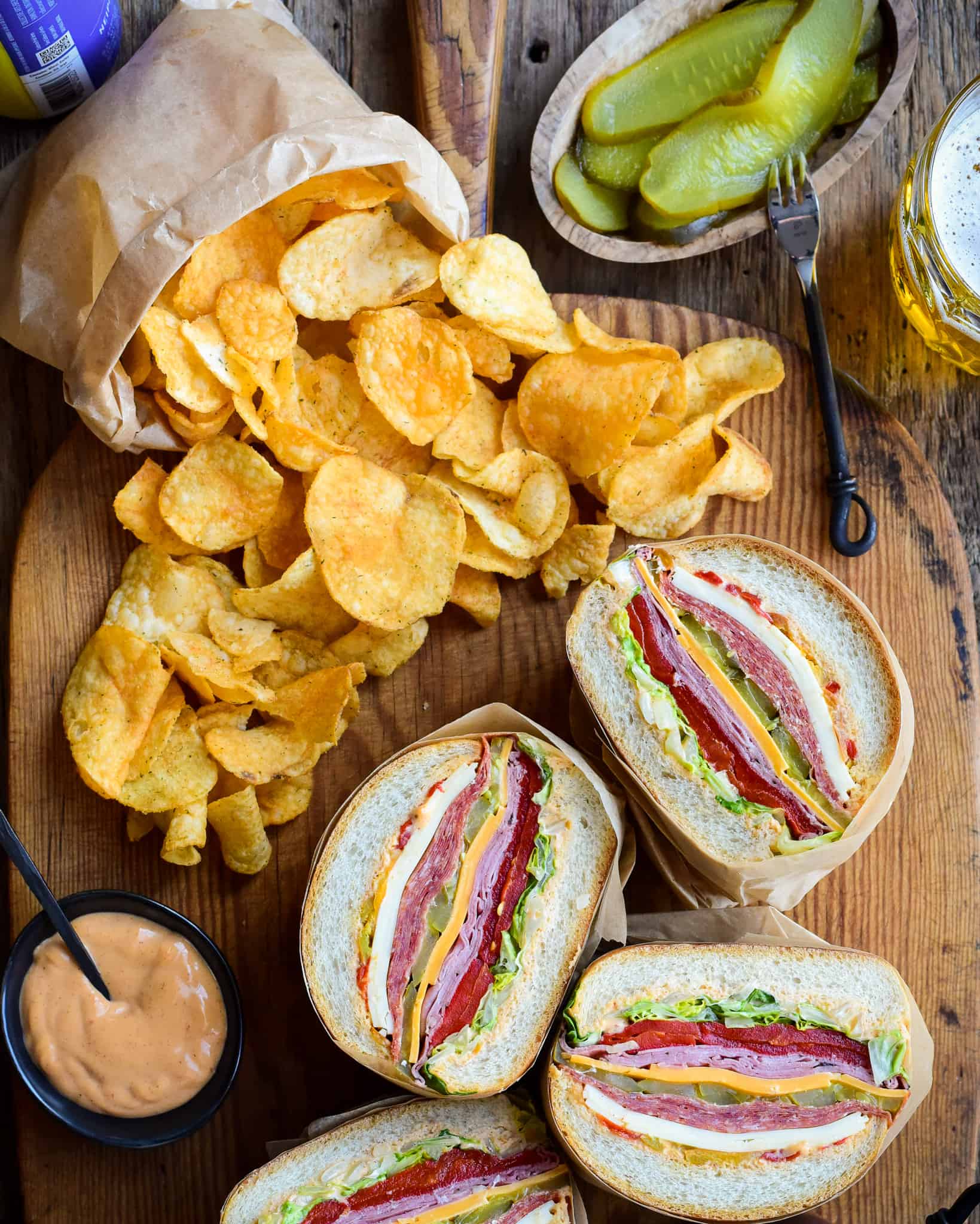 Stuffed sandwich halves reveal the layers of varieties of meat and cheese.