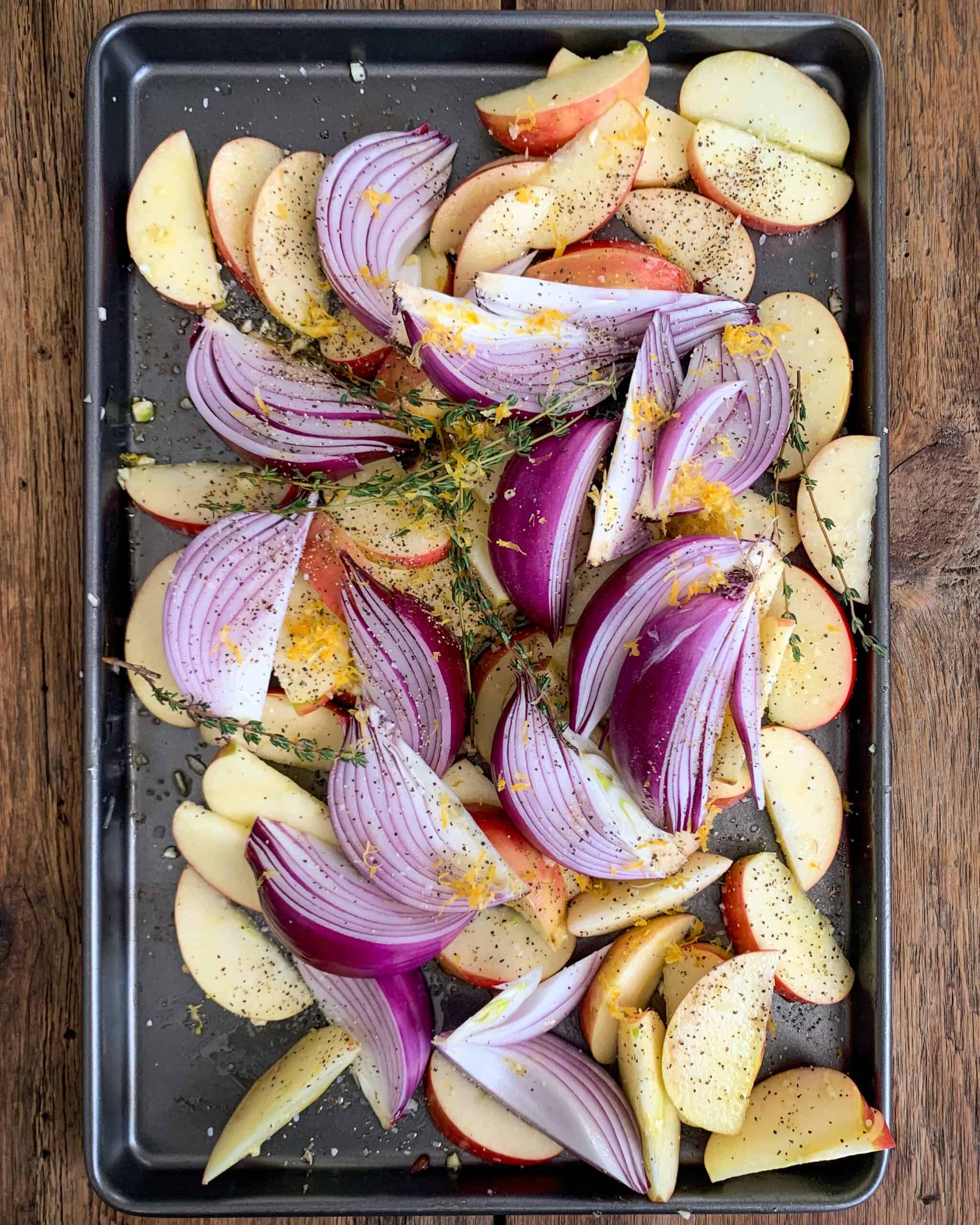 Toss together apples, onions, thyme, 2 tablespoons of olive oil, garlic, lemon zest, ½ salt and 1 teaspoon black pepper. Mix the apple mixture with the fennel and potatoes.