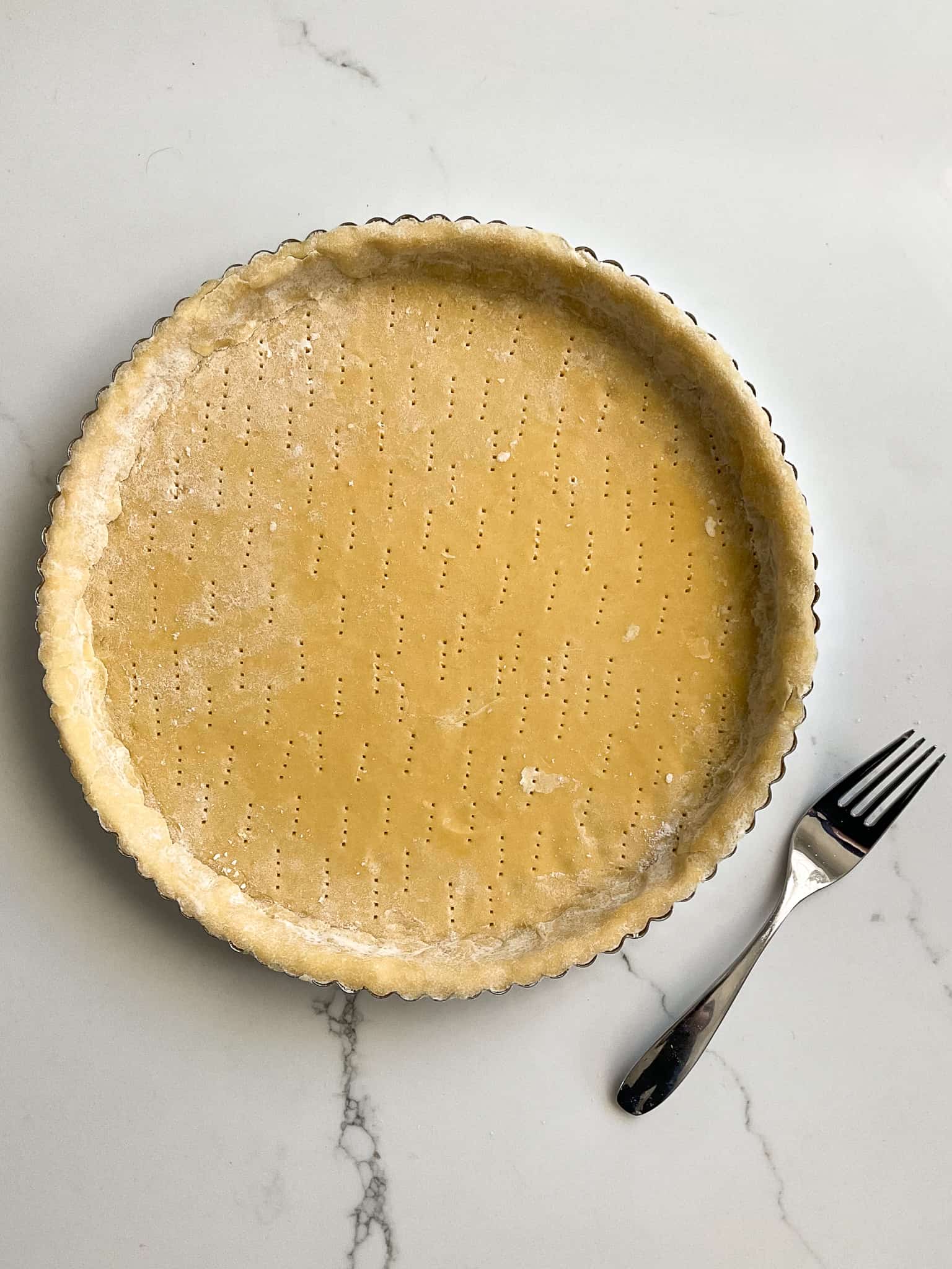 Using a fork, prick the bottom of the crust from side to side.