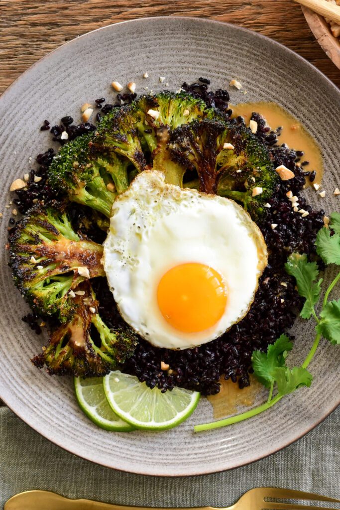 A plate which shows how to layer the ingredients of this stir fry rice, egg and broccoli dish.