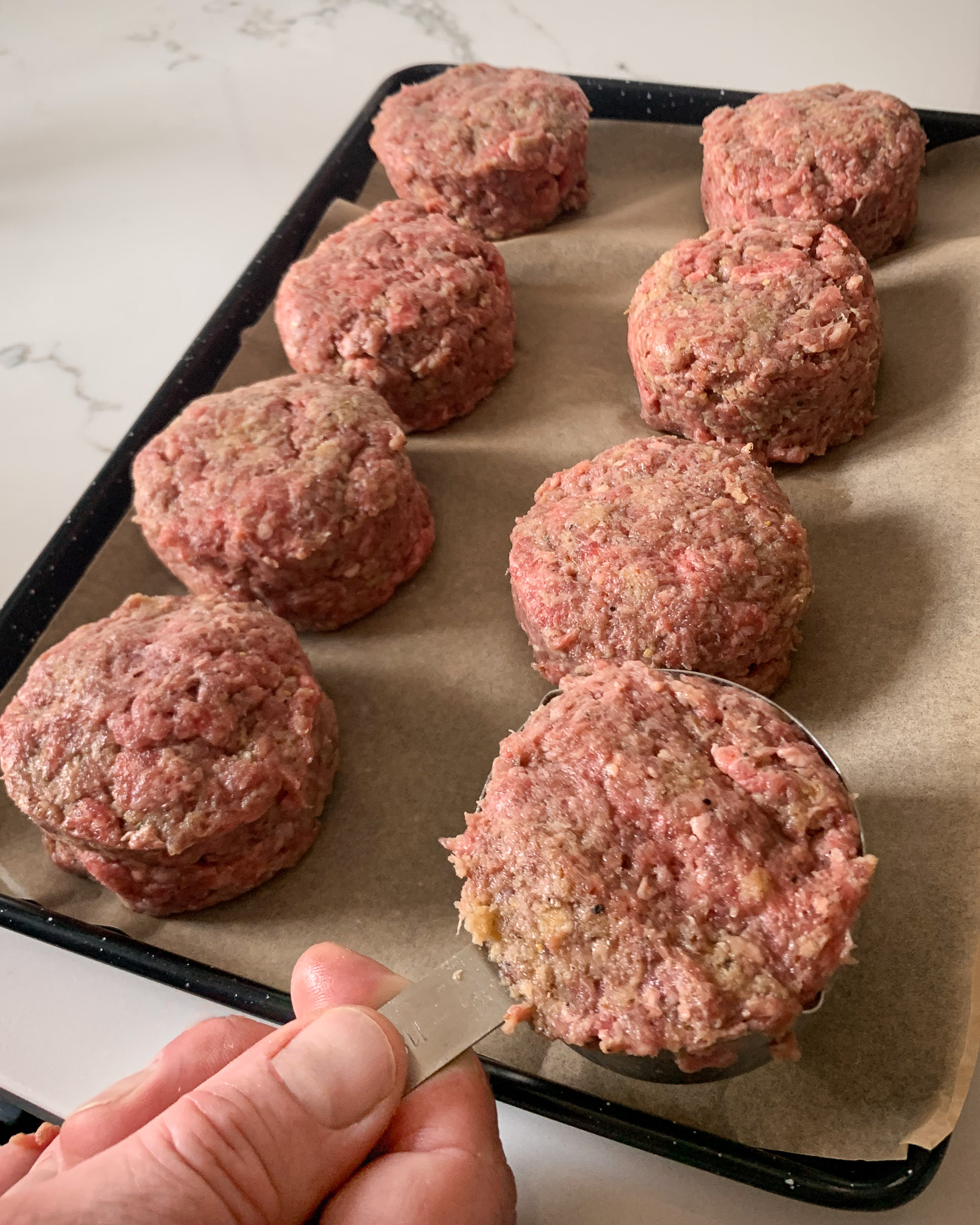 Use a ½ cup measuring cup to measure form into 8 equal size beef patties