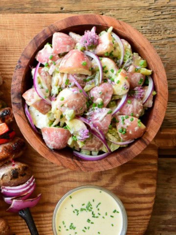 A dill pickle salad in a wooden bowl.