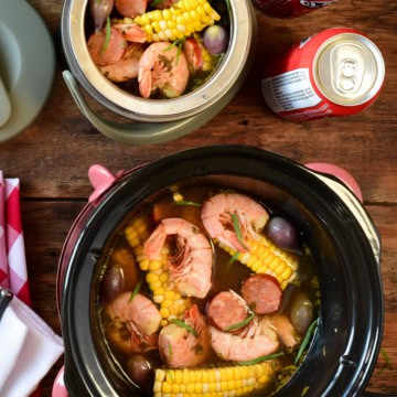 Two crockpots, both filled with a shrimp bowl. Once crockpot is a mini that is portable.