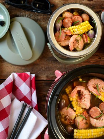 Two crockpots, both filled with a shrimp bowl. Once crockpot is a mini that is portable.