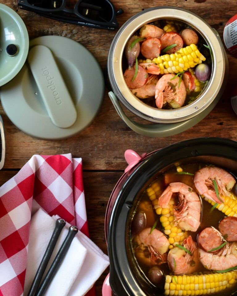 Two crockpots, both filled with a shrimp bowl. Once crockpot is a mini that is portable.