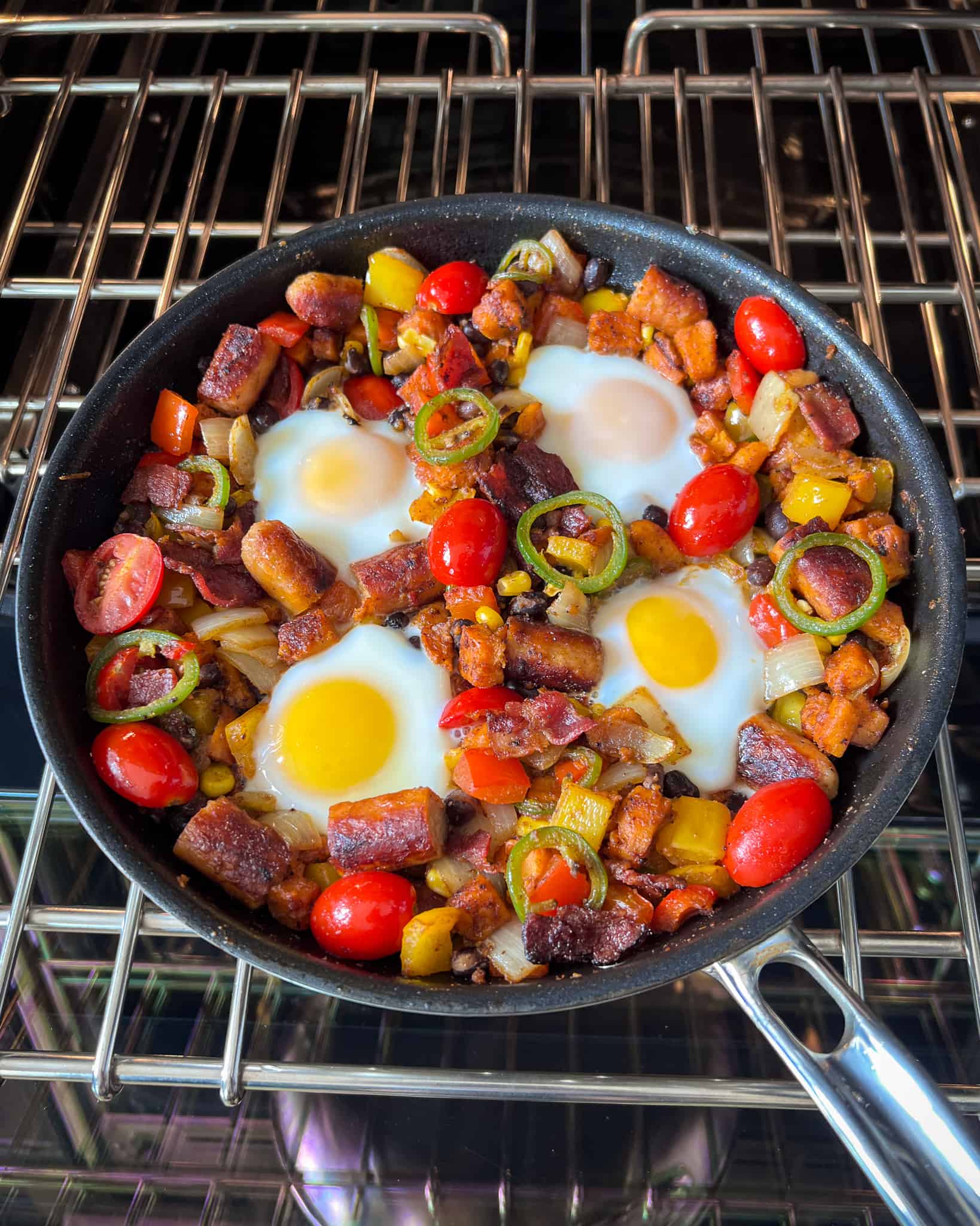The eggs have cooked in the skillet hash and is ready to eat.