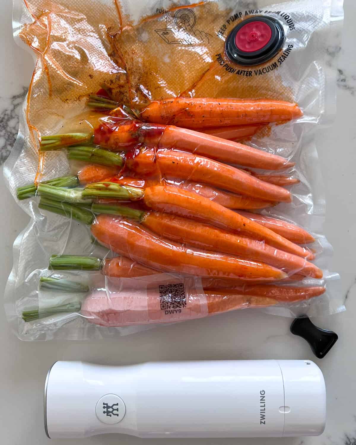 Vacuum sealed carrots with a sous-vide stick.