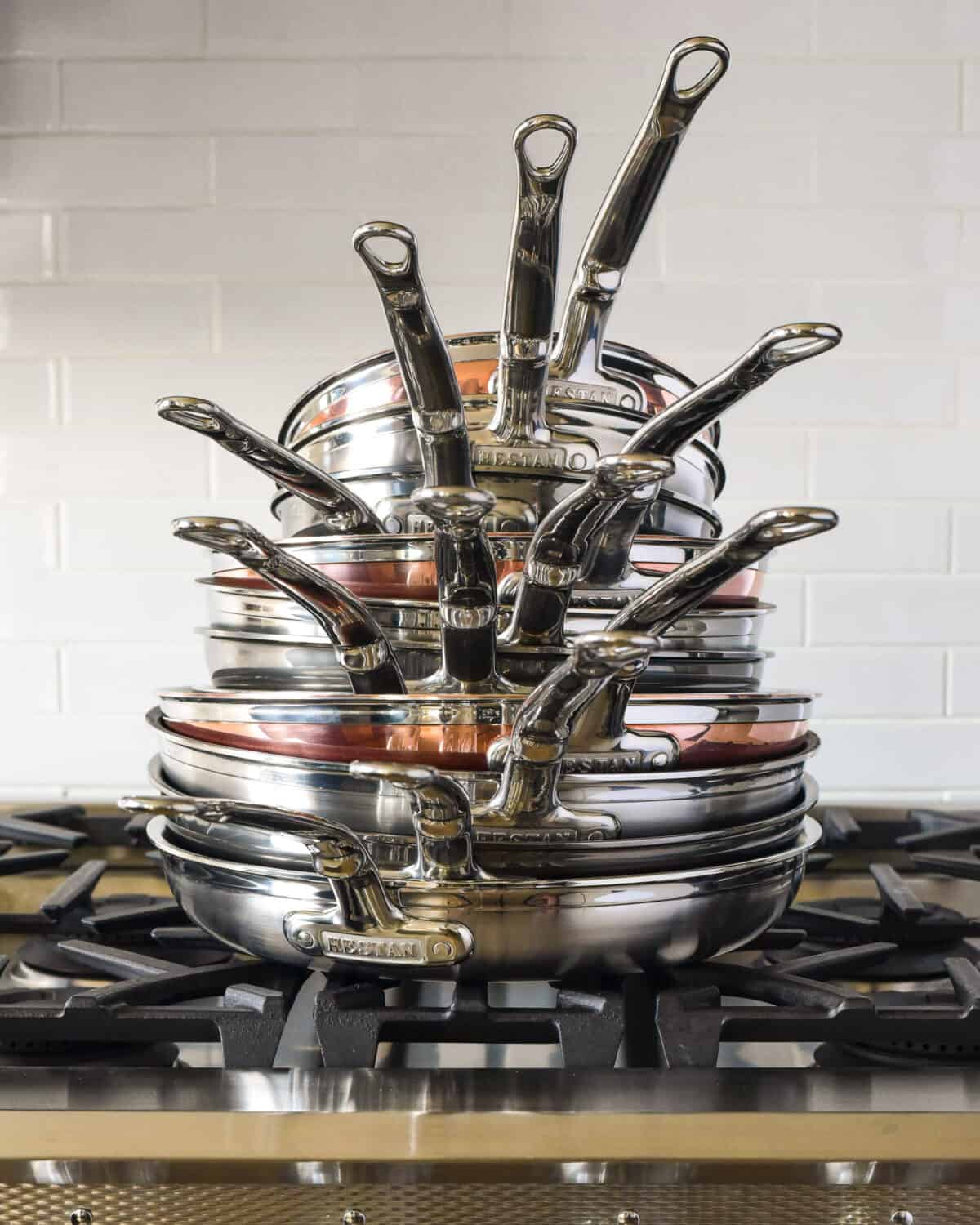 A stack of skillets of various sizes on a range.