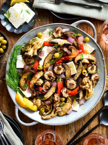 A plate of food with a variety of grilled mushrooms and other ingredients.