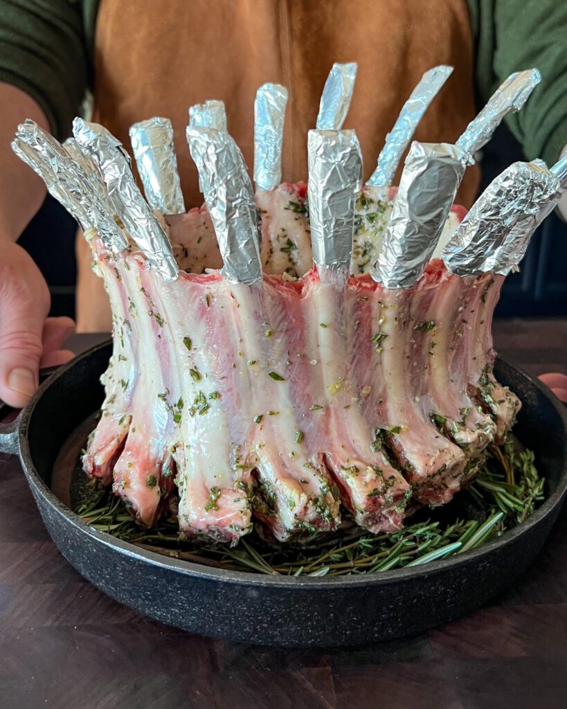 A prepared crown rack of lamb ready to get roasted.