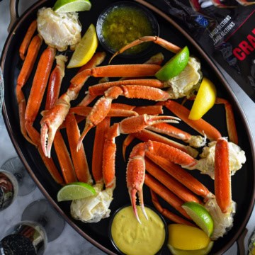 A platter of Wild Caught Snow Crab Legs with Spicy Mustard Dip.