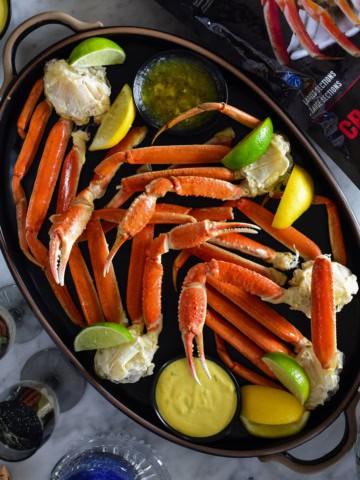 A platter of Wild Caught Snow Crab Legs with Spicy Mustard Dip.