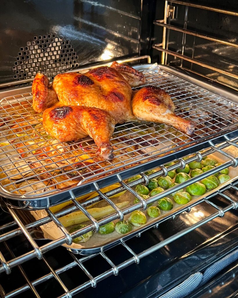 Spatchcock chicken on a rack in the oven. 