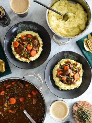 Two bowls of Guinness and Beef stew with mashed potatoes. This stew is basically braised beef in Guinness and is so good.