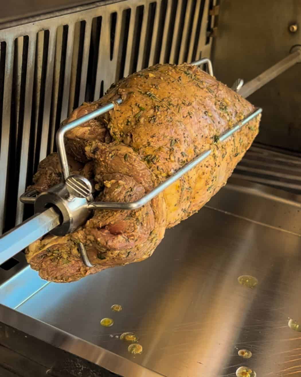 A leg of lamb placed on the spit onto the rotisserie.