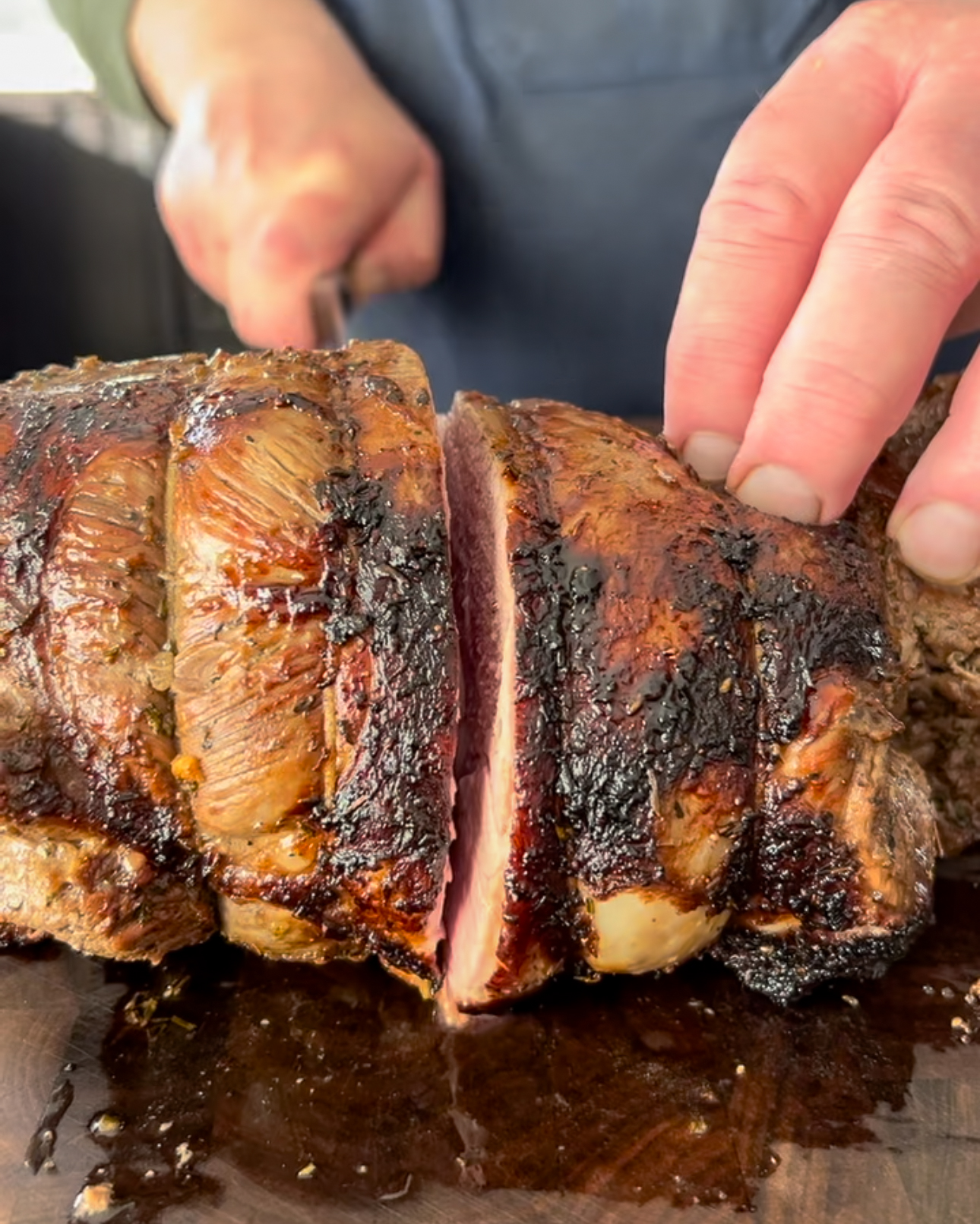 Slice the lamb roast with a sharp knife.