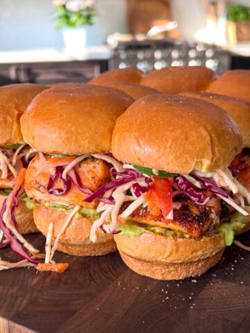 Nine salmon sliders with a colourful coleslaw and guacamole.