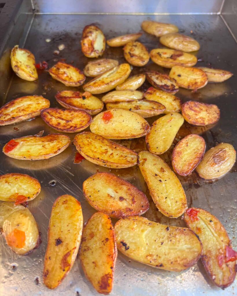 Golden brown fingerling potatoes on the griddle.