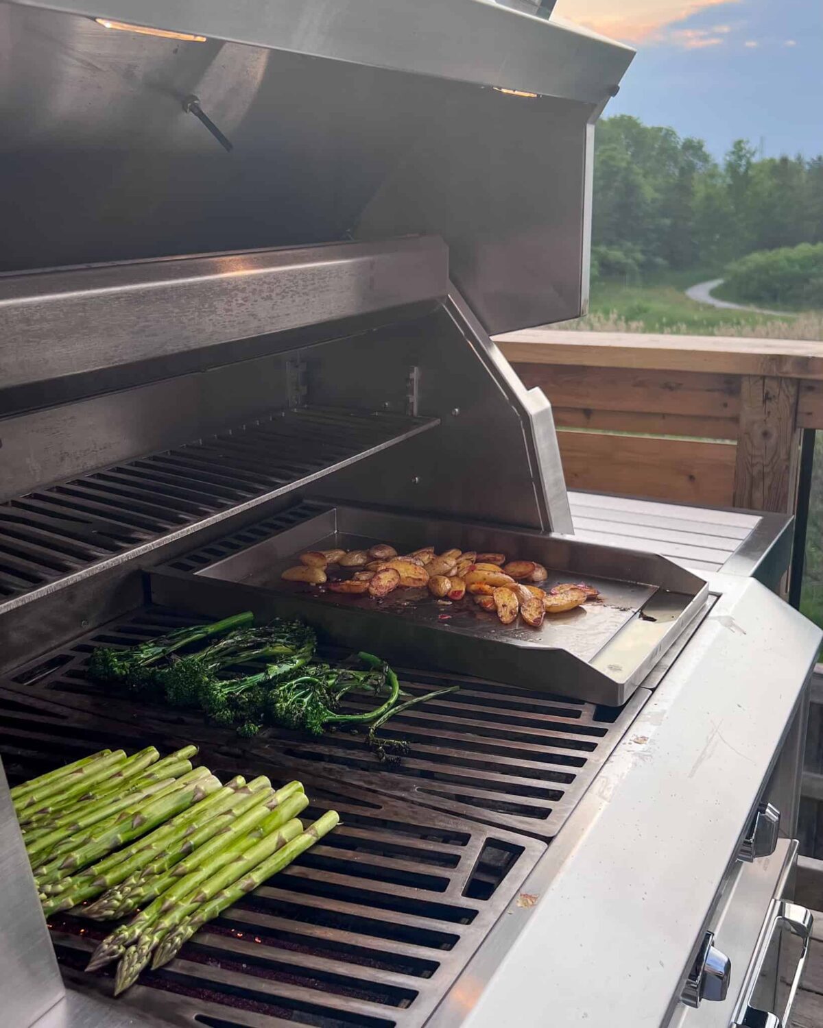 Asparagus and broccolini on the grill with roasted potatoes on the griddle.