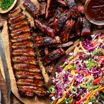 A pile of BBQ Baby Back Ribs with Psychedelic Slaw.