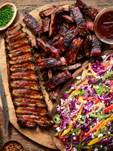 A pile of BBQ Baby Back Ribs with Psychedelic Slaw.