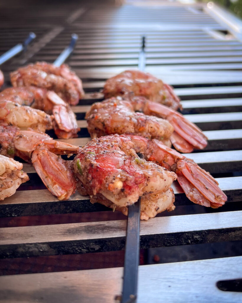 Colossal shrimp skewers on the grill.