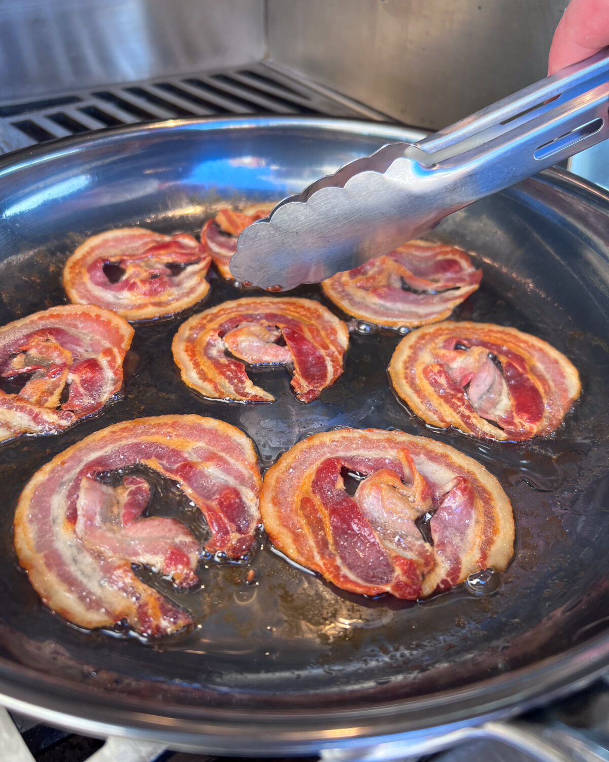 Cooking pancetta in a skillet on the grill. 