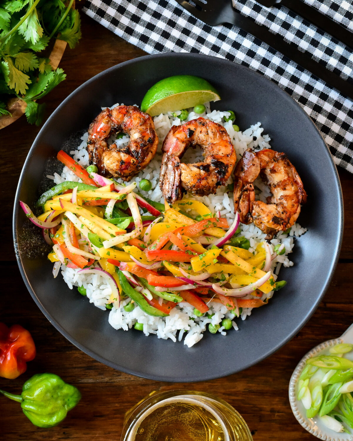 A bowl of jerk shrimp with rice and slaw.