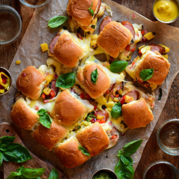 Pull apart sliders with ham garlic sausages and pineapple salsa.