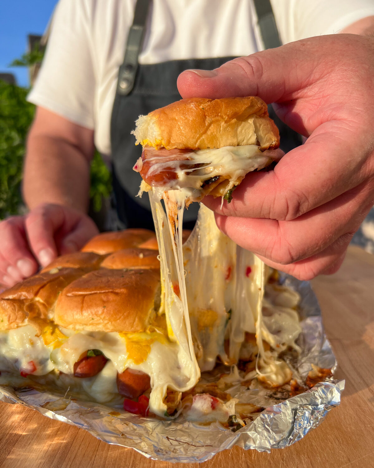 Pull apart sliders with someone pulling one apart with a cheese pull!
